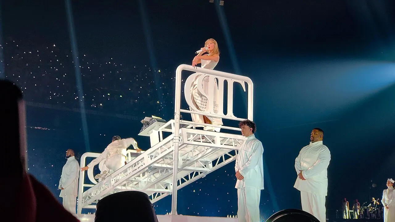 Taylor Swift performing on stage during the Eras Tour in Paris in 2024